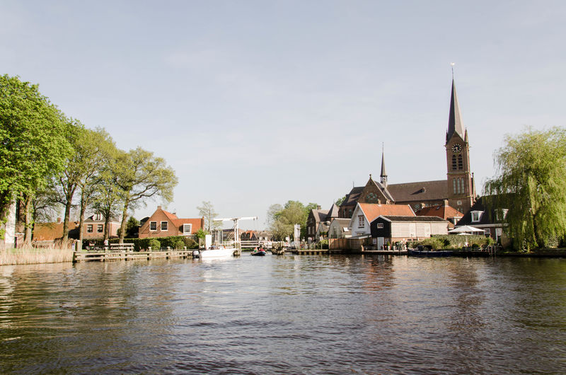 View of oudekerk and old towns from the amstel river on a boat