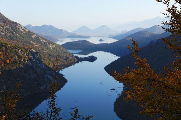 Scenic view of lake and mountains against sky