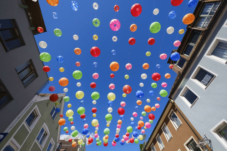 Germany, bavaria, kempten, colorful paper lanterns hanging against clear blue sky
