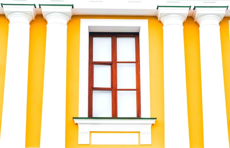 Low angle view of yellow window on building