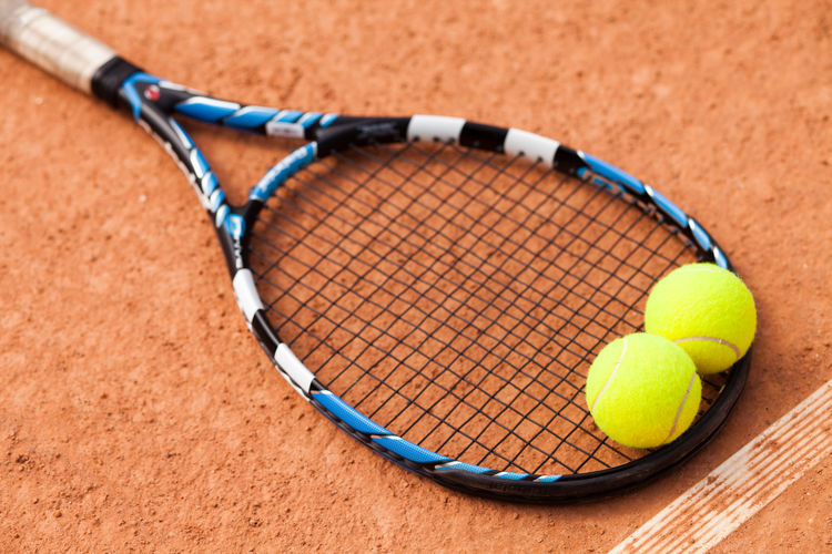 Close-up of tennis balls on racket