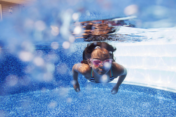 Close-up of girl swimming in pool
