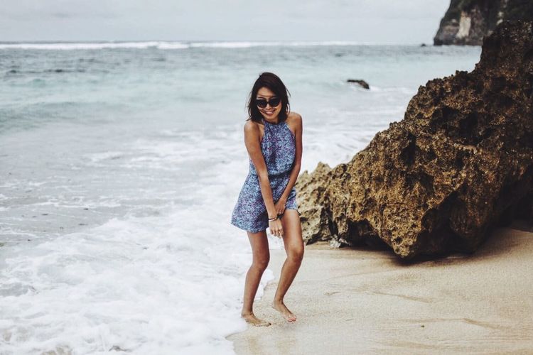 Full length of young woman on beach