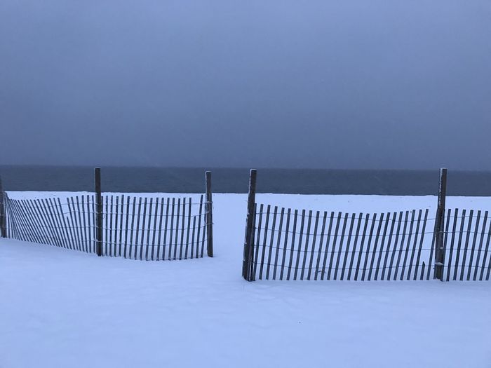 Scenic view of snow covered land against clear sky at chatham, cape cod