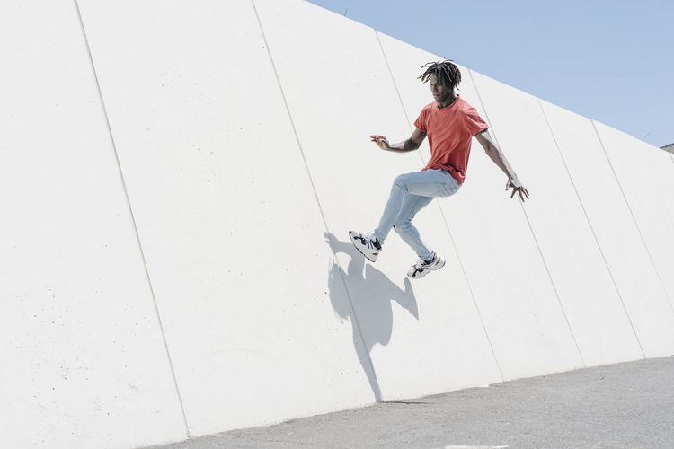 Energetic man jumping on ramp