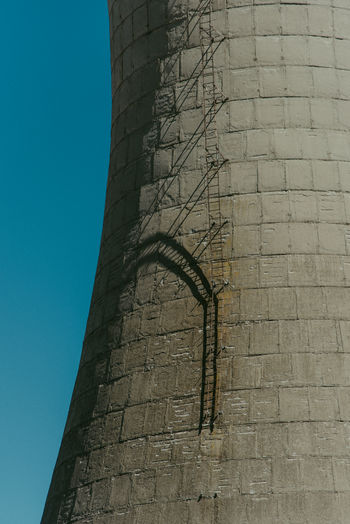 Low angle view of building against clear blue sky