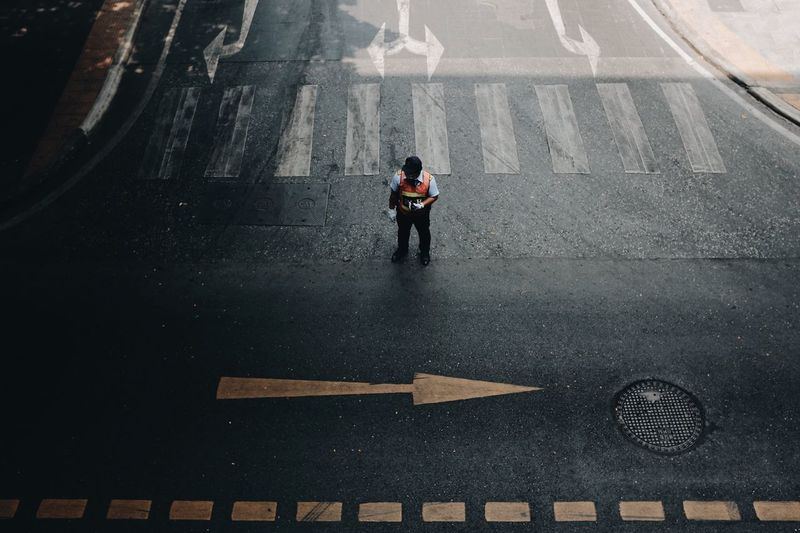 High angle view of police man standing on road