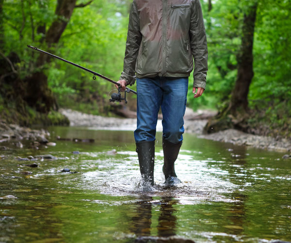 Full length of man standing on riverbank