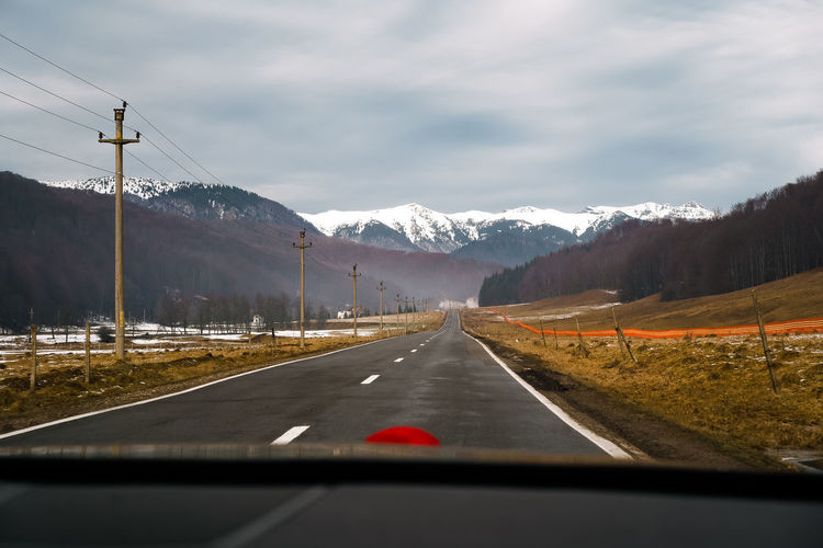 Winter road seen through car windshield