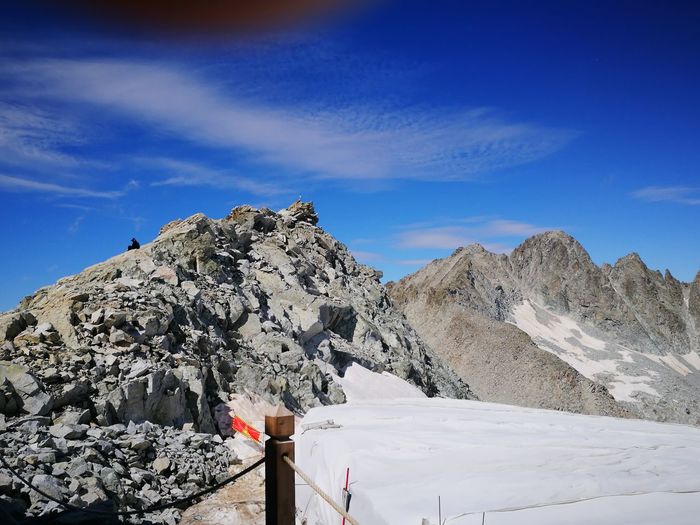 Scenic view of snowcapped mountains against blue sky