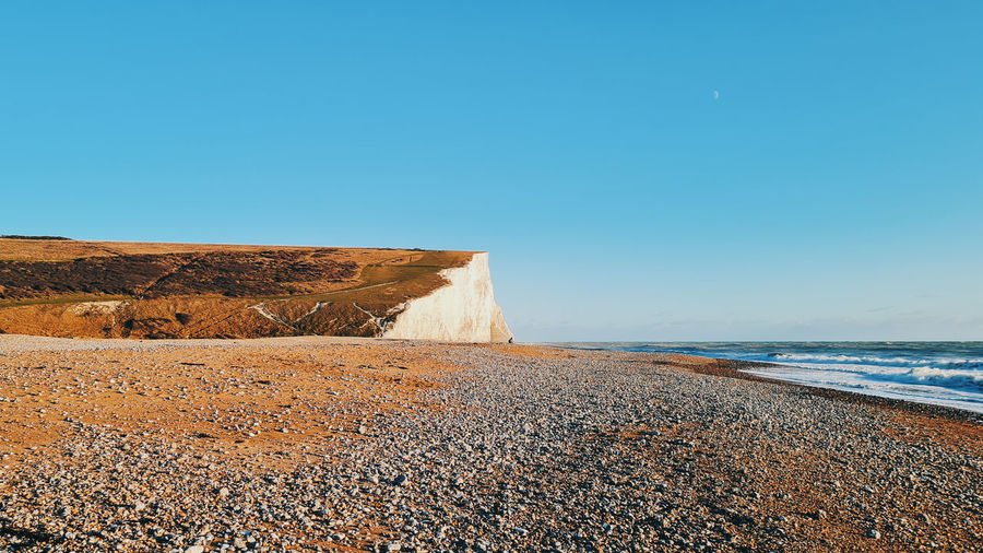 Scenic view of sea against clear blue sky