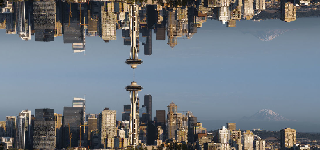 Panoramic view of buildings in city against sky