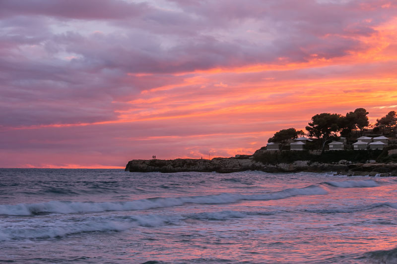 Scenic view of sea against orange sky