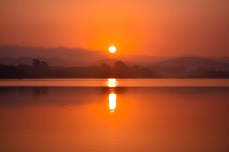 Scenic view of lake against romantic sky at sunset