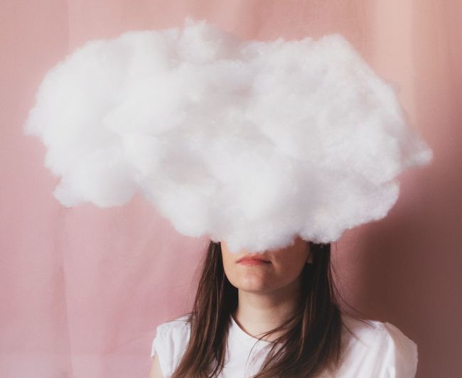 Portrait of woman against white cloud