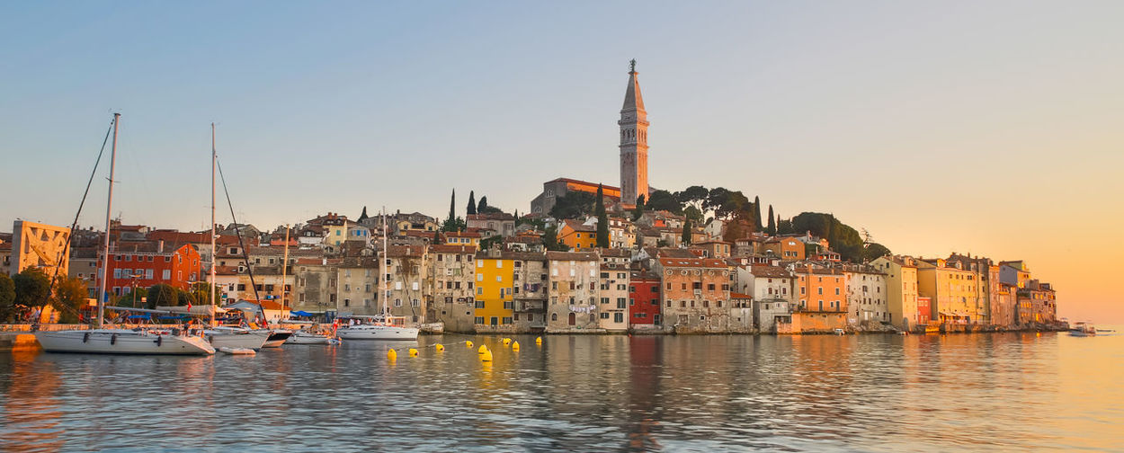 Sailboats in city at waterfront