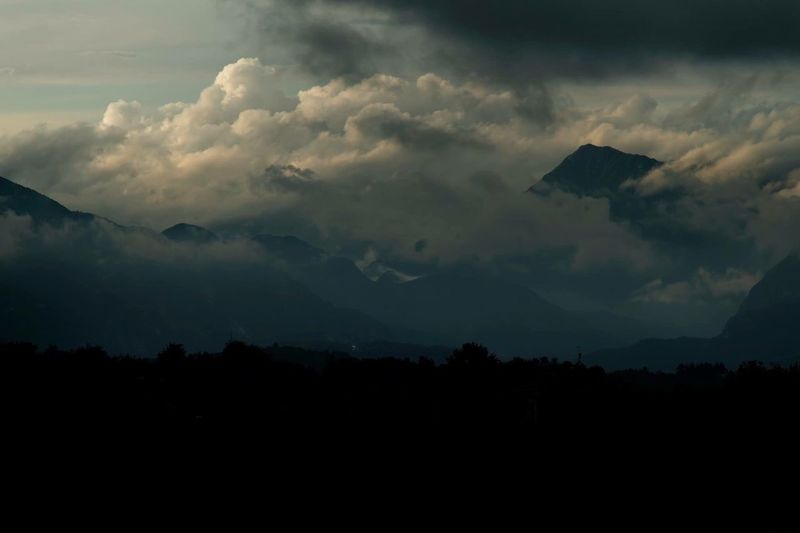 Scenic view of silhouette mountains against sky
