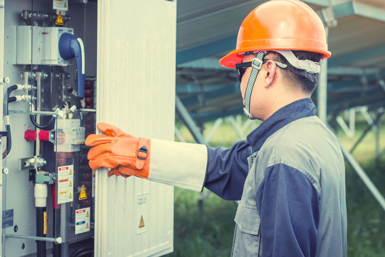Manual worker examining machinery