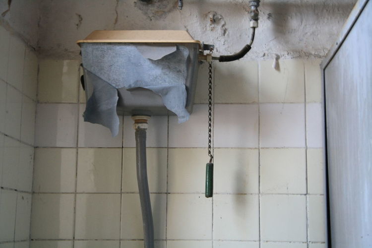 Flush tank in abandoned toilet