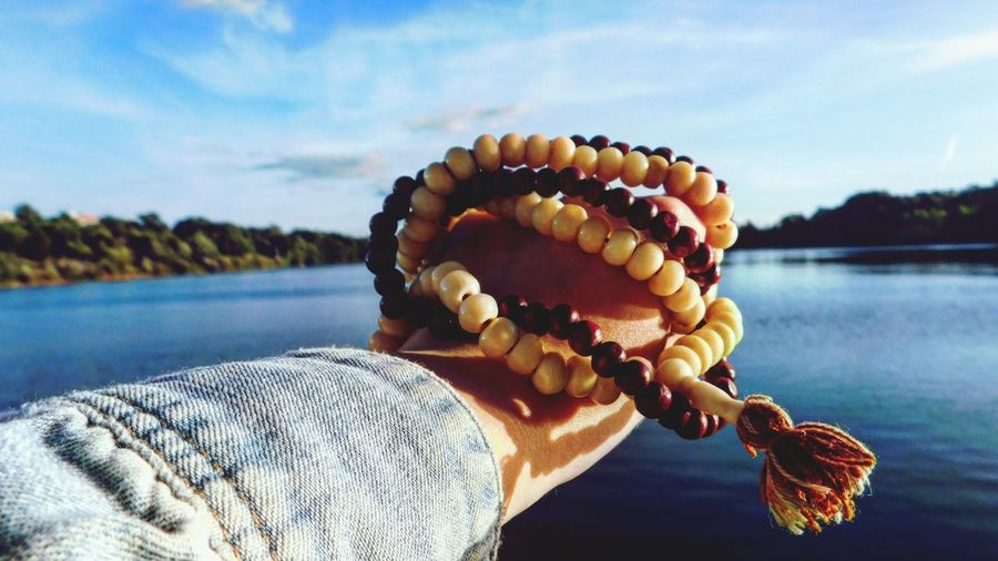 Persons hand holding prayer beads