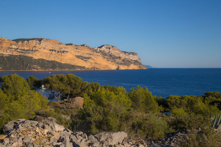 Scenic view of sea against clear blue sky