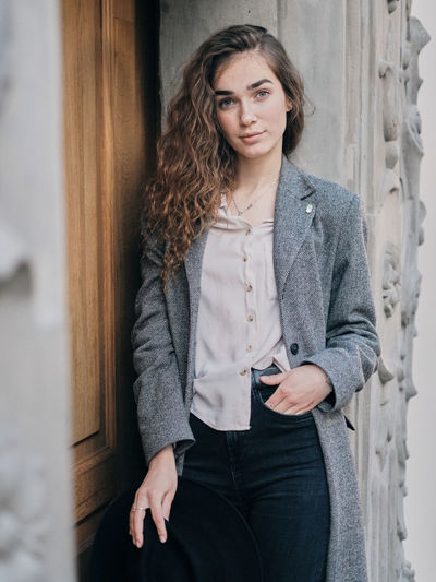 Portrait of woman standing at entrance