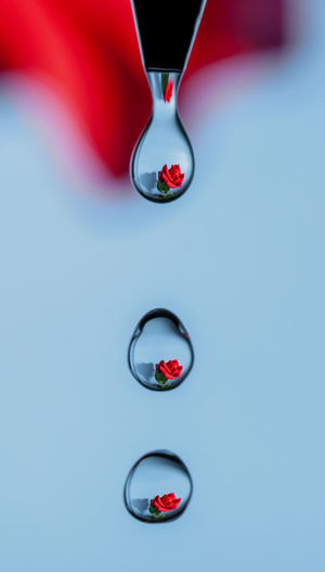 Close-up of water drops on glass against white background