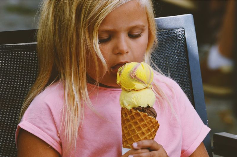 Close-up of girl eating ice cream cone