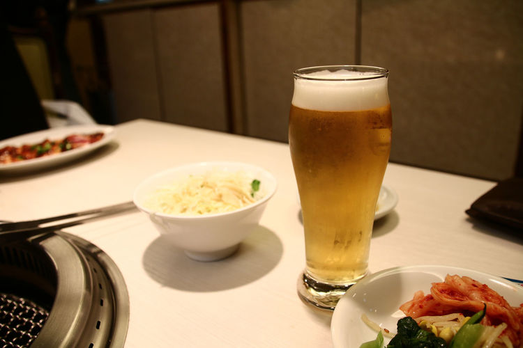 Beer in glass and food on table
