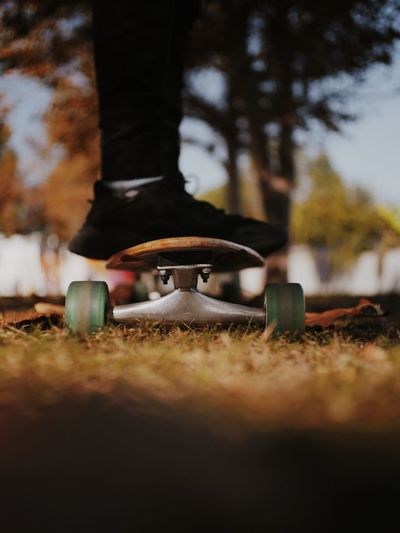 Low section of person skateboarding at park