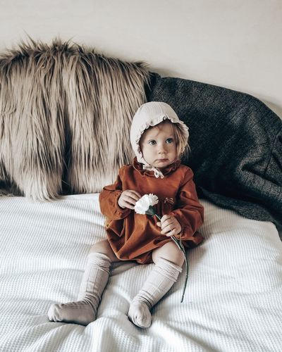 Portrait of cute nordic fashion toddler girl sitting 