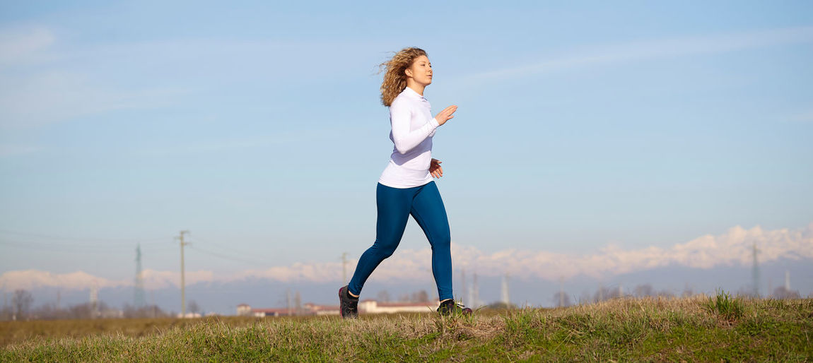 Woman running on grassy field