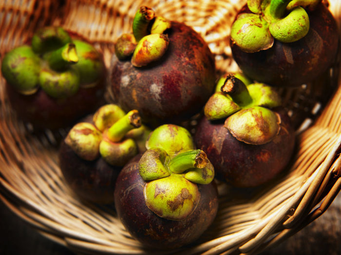 Close-up of mangosteen in basket