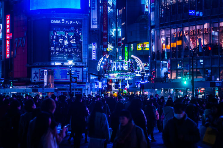 Crowd at  shibuya crossing in tokyo japan at night against neons