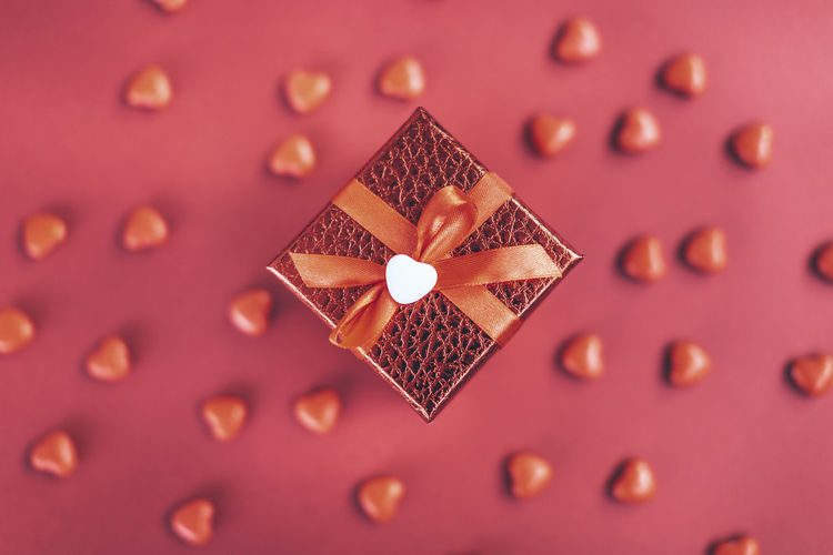 Red gift box on the background of hearts for valentine's day