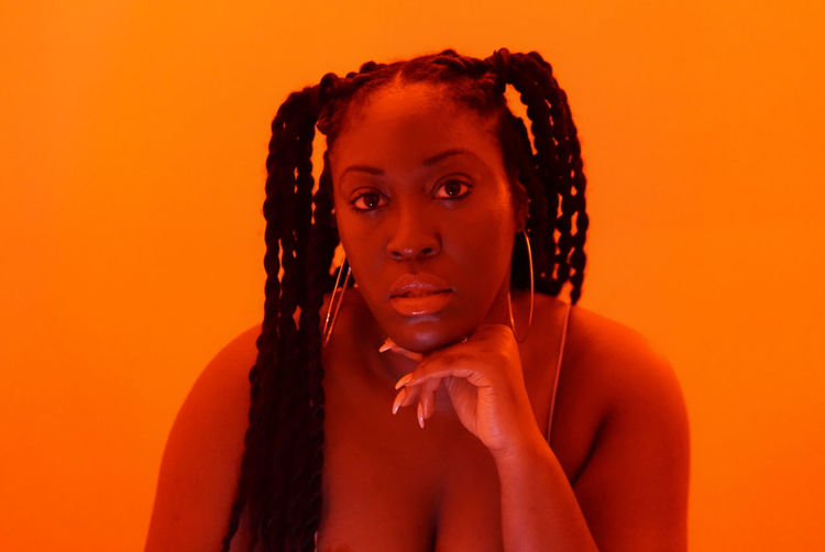 Black woman braids in orange 