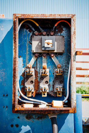 Old rusty electric meter box on wall