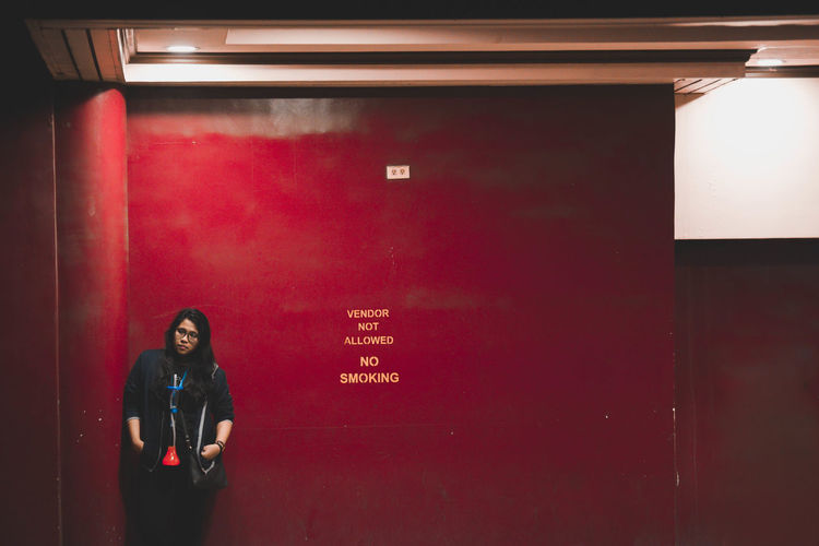 Woman standing against wall