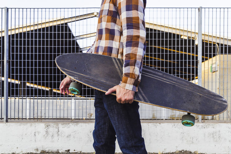 Low section of man standing on skateboard