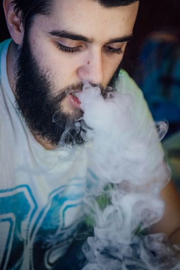 Close-up of man smoking hookah