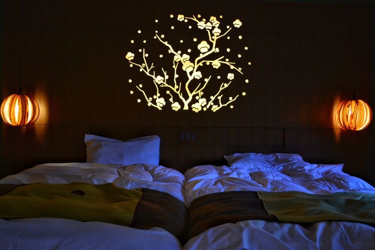 Illuminated lanterns in luxury hotel bedroom