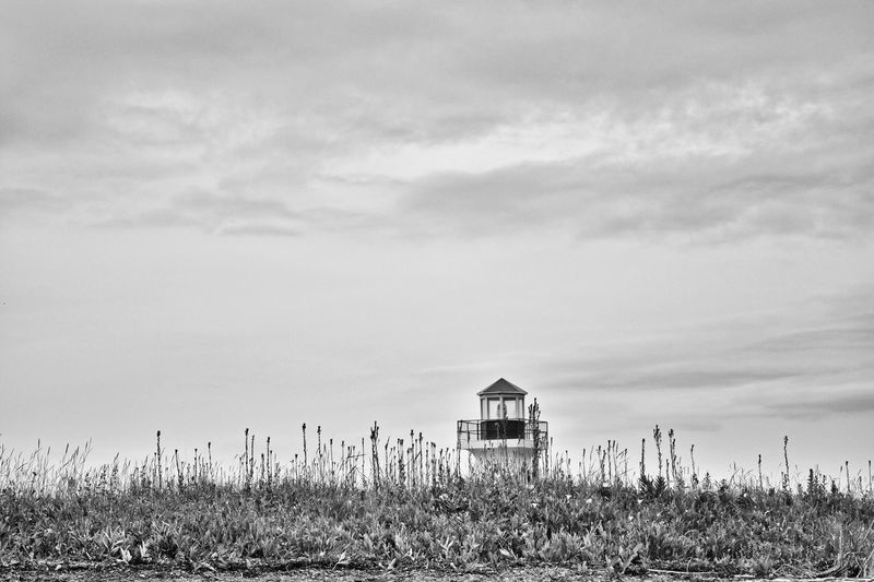 Lifeguard hut on land against sky