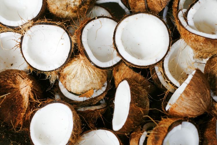 Full frame shot of halved coconuts