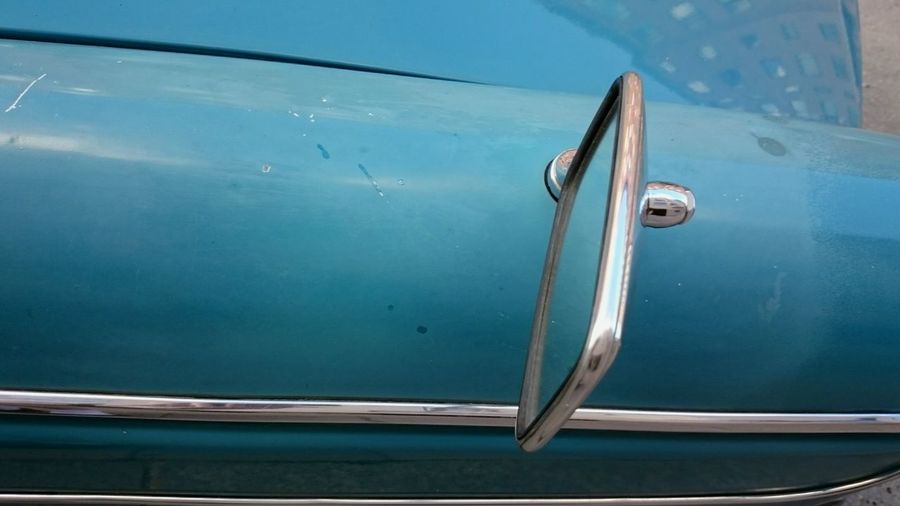 Blue car detail with rear-view mirror