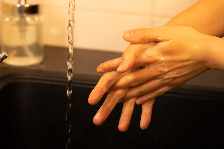 Close-up of woman holding wet hand