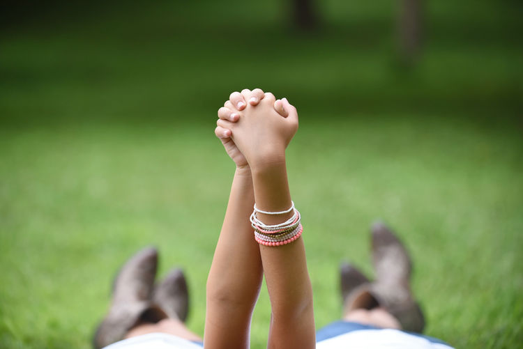 Cropped image of sisters holding hands in park