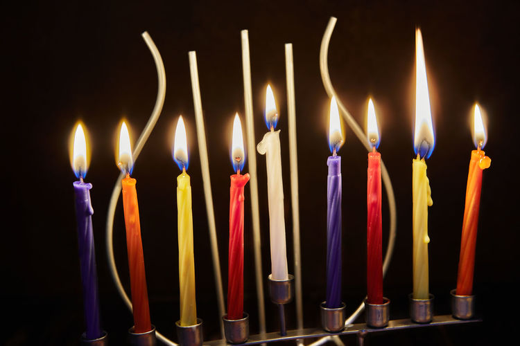Happy hanukkah and hanukkah sameach - traditional jewish candlestick with candles on dark background