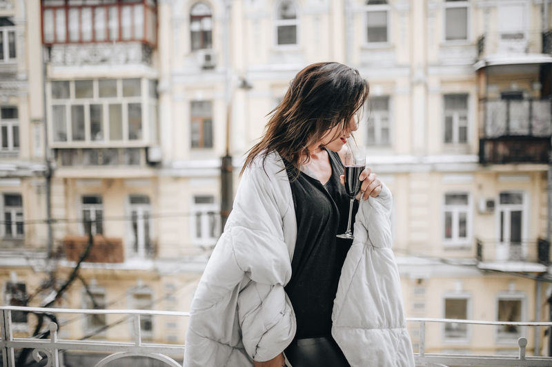 Woman standing on mobile phone in city