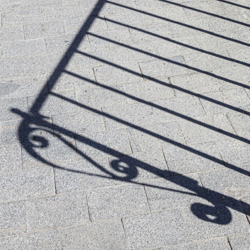 Shadow of bicycle on footpath