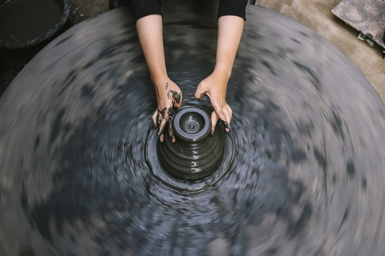 Hands of a nepalese pottery. selection focus with motion blur